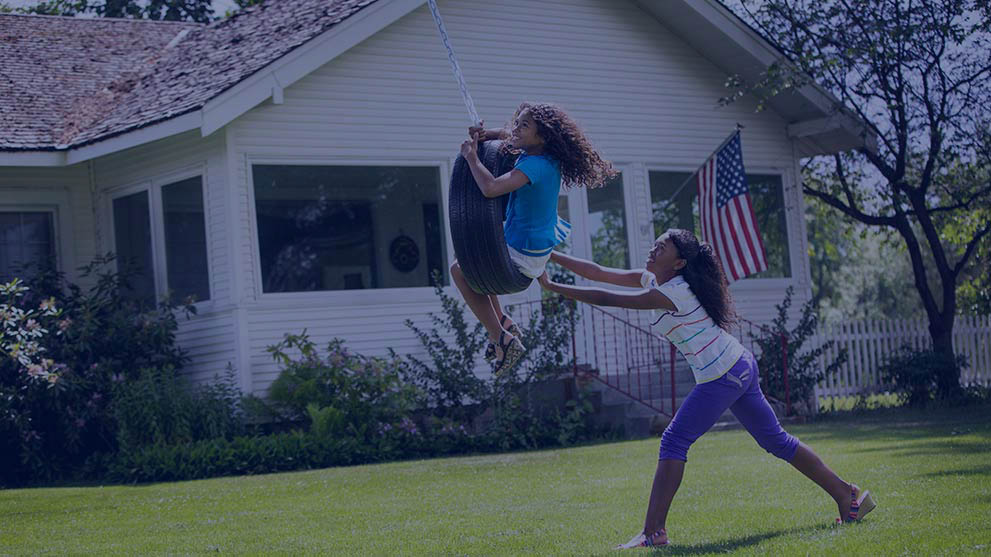 Two girls playing in their front yard