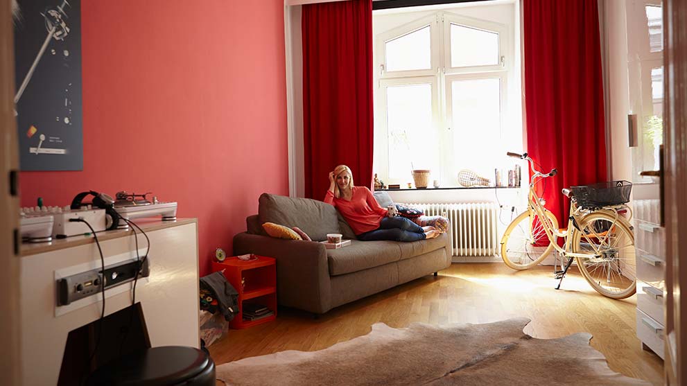 woman sitting on her couch admiring her modern furnishings