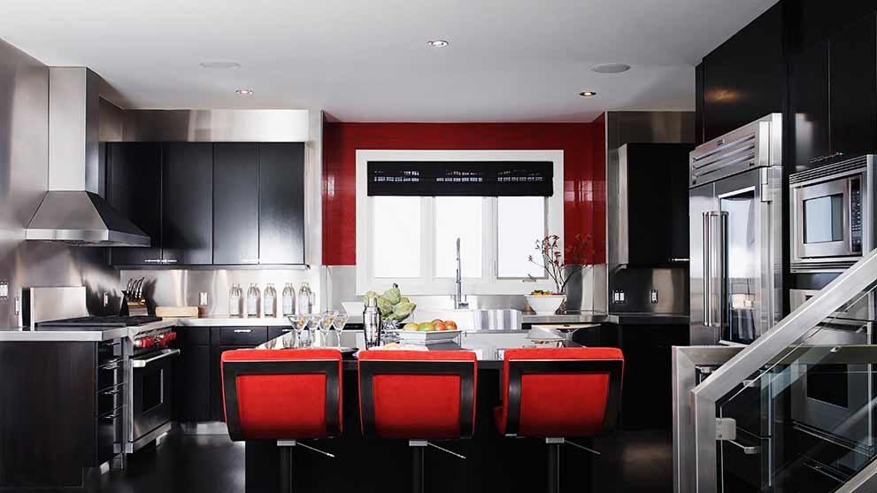 Modern kitchen with black cabinets and red accents
