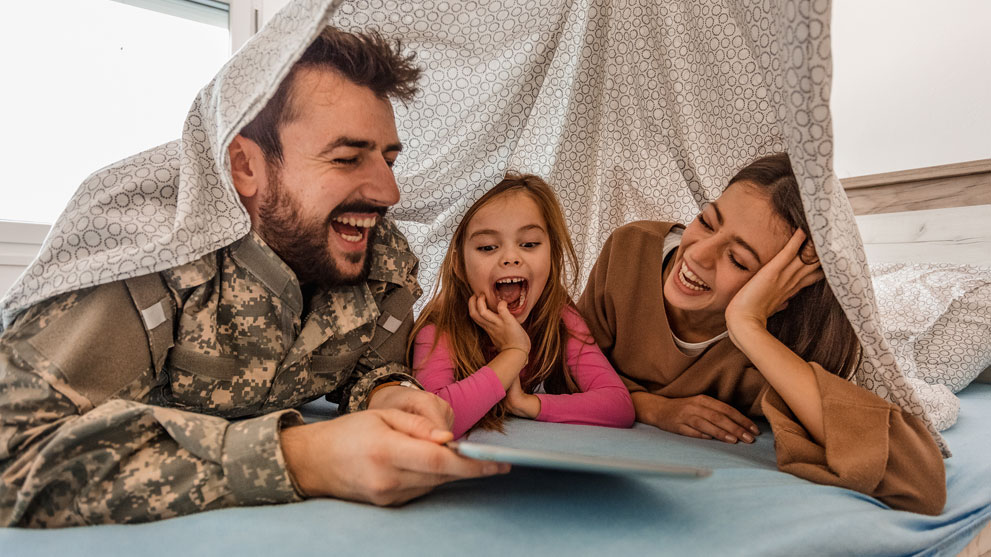 Military family laughing at home