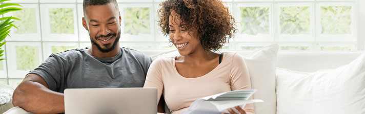 happy couple creating a savings plan