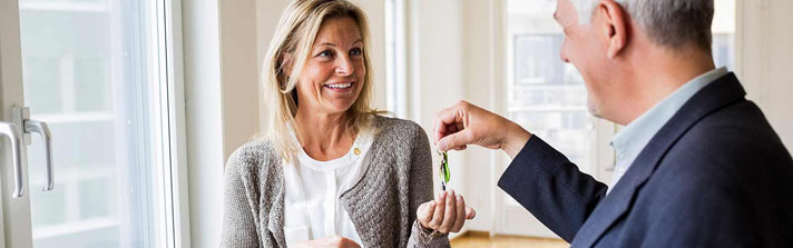 Woman receiving keys to the condo