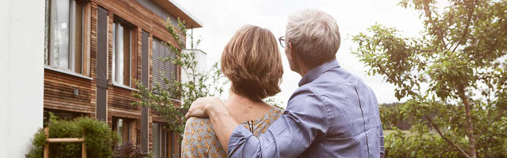 husband and wife admiring a home for sale