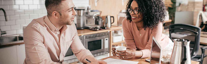 Couple sitting in the kitchen discussing