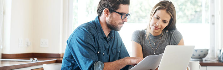 Shot of a young couple working on their finances together at home