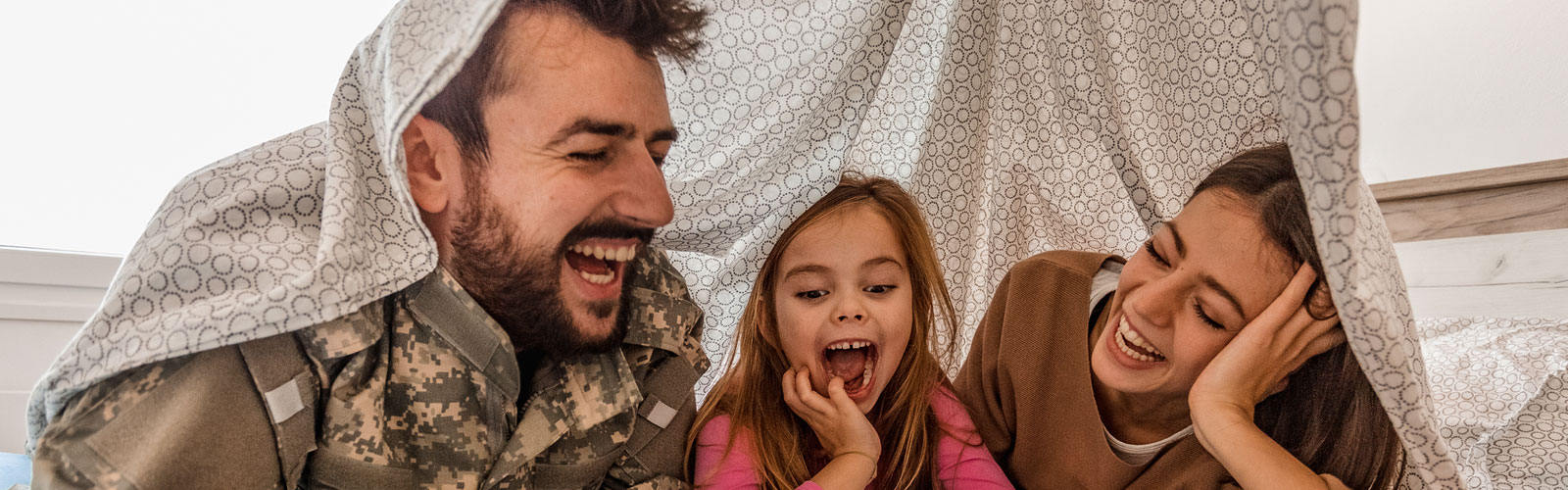 Military family laughing at home