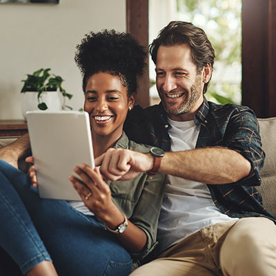 couple reading something together on sofa