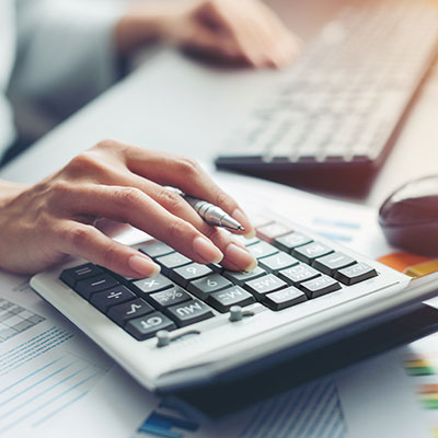 closeup of a woman's hand on a keyboard's number pad