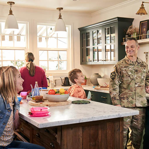 family in kitchen, dad in uniform