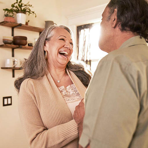 couple laughing in kitchen