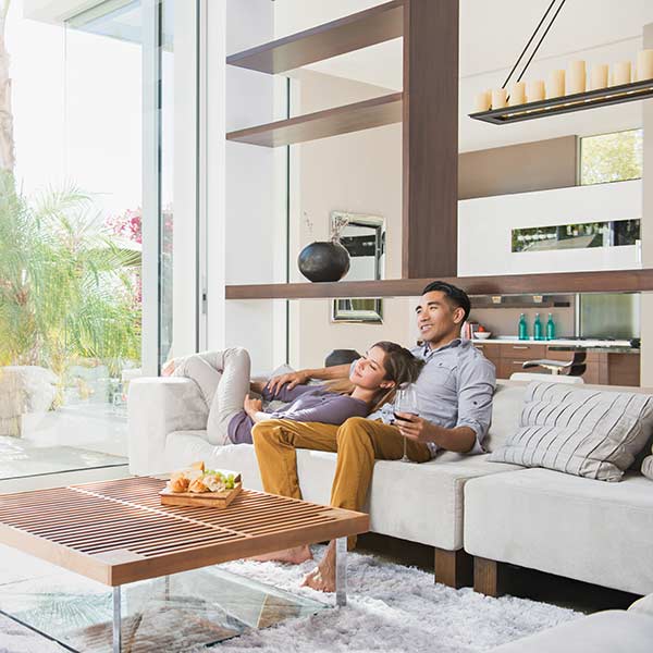 Couple relaxing together on sitting room sofa