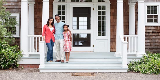 family standing in front of residential home