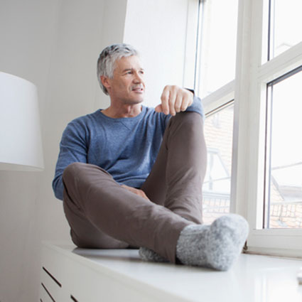 Man looking out window