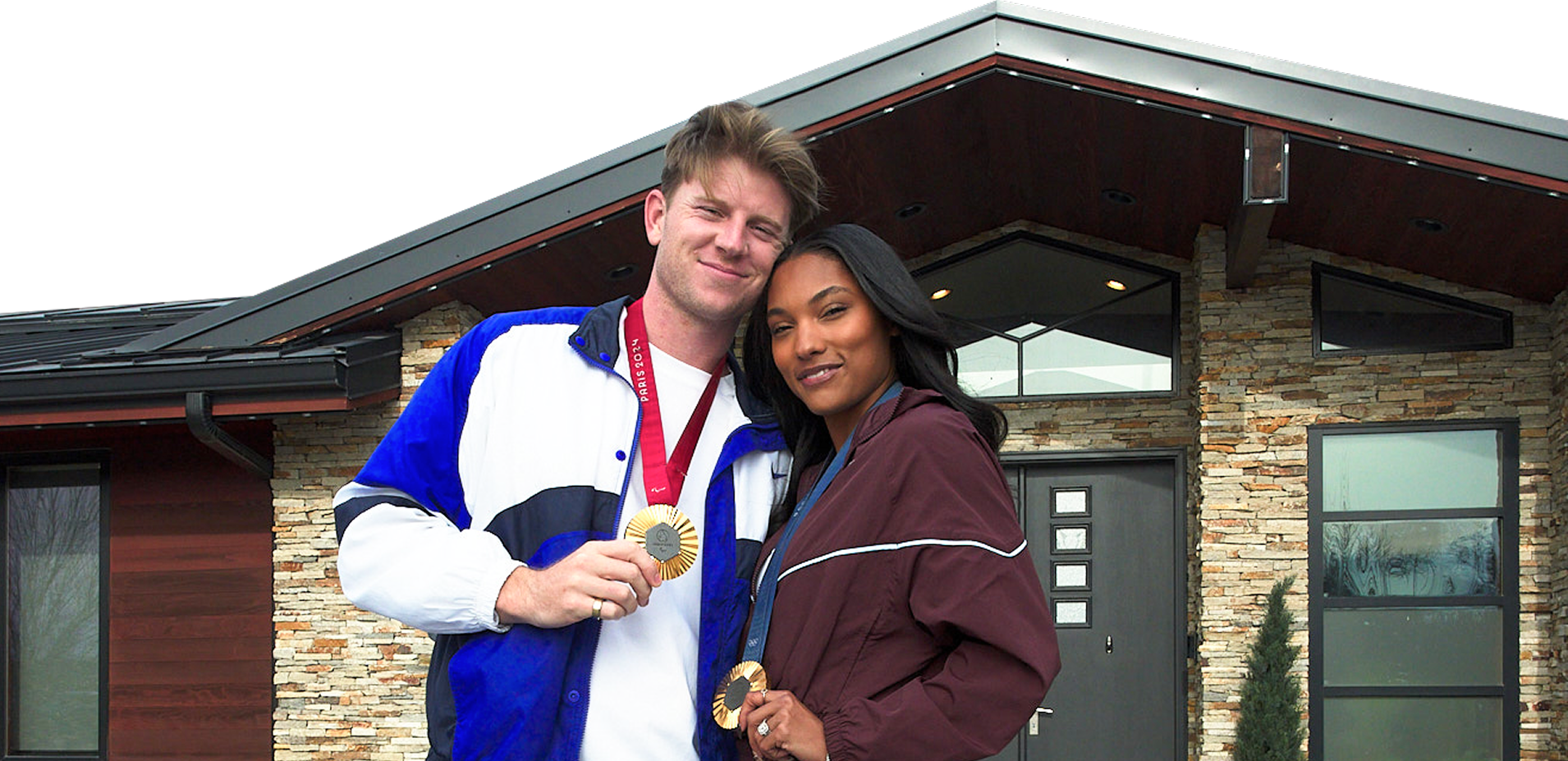 Woodhalls stand in front of their home